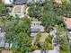 Aerial perspective revealing the property's layout with surrounding trees, a pond, and neighborhood context at 4315 W Azeele St, Tampa, FL 33609