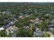 An aerial view of lush, green neighborhood homes with beautiful landscaping and mature trees at 4315 W Azeele St, Tampa, FL 33609