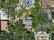Aerial view of the home with a generous lot size, mature trees, and a pond in the backyard at 4315 W Azeele St, Tampa, FL 33609