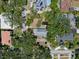 A birds-eye view of a cozy home with lush trees around it, and other houses nearby at 4315 W Azeele St, Tampa, FL 33609