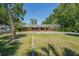 Charming one-story brick home featuring a large front lawn with mature trees offering a park-like setting at 4315 W Azeele St, Tampa, FL 33609