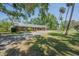 Charming brick home with a well-manicured lawn, mature trees and long drive-way at 4315 W Azeele St, Tampa, FL 33609