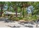 Corner lot view showcasing mature landscaping and a charming one-story brick home on a tree lined street at 4315 W Azeele St, Tampa, FL 33609