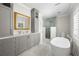 Bright bathroom with large vanity, glass enclosed shower, and soaking tub at 5001 W Dickens Ave, Tampa, FL 33629