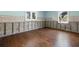 Open bedroom featuring wood flooring and two windows at 5001 W Dickens Ave, Tampa, FL 33629