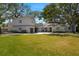 Charming white brick home with a well-manicured lawn and inviting front porch at 5001 W Dickens Ave, Tampa, FL 33629