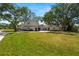 Beautiful two-story home featuring a large front yard and mature landscaping at 5001 W Dickens Ave, Tampa, FL 33629