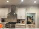 Bright kitchen with stainless steel appliances, white cabinets, and tile backsplash at 5001 W Dickens Ave, Tampa, FL 33629