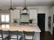 Well-lit kitchen with stainless steel appliances, a large island, and white subway tile at 5001 W Dickens Ave, Tampa, FL 33629