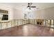 Spacious living room with dark wood floors, ceiling fan and two windows at 5001 W Dickens Ave, Tampa, FL 33629