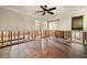 Open living area with wood flooring, ceiling fan, and view to an open doorway at 5001 W Dickens Ave, Tampa, FL 33629