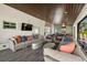 Spacious covered patio with a lounge area, a mounted TV, and stylish decor at 5001 W Dickens Ave, Tampa, FL 33629