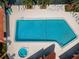 Aerial view of community pool with spa and ample seating and palm trees at 502 Hammock Pine Blvd # 502, Clearwater, FL 33761