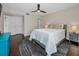 Bedroom featuring ceiling fan, TV, nightstand and an attached bathroom with a glass enclosed shower at 502 Hammock Pine Blvd # 502, Clearwater, FL 33761