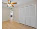 Bedroom featuring wood-look floors, ceiling fan, and a large closet at 502 Hammock Pine Blvd # 502, Clearwater, FL 33761