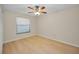 Bright bedroom with a ceiling fan, window with blinds, and wood-look flooring at 502 Hammock Pine Blvd # 502, Clearwater, FL 33761