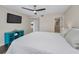 Bedroom with ceiling fan, television, view to kitchen and connected bathroom with glass shower at 502 Hammock Pine Blvd # 502, Clearwater, FL 33761