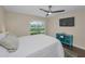 Cozy bedroom featuring a ceiling fan, TV, and a view of the outdoors at 502 Hammock Pine Blvd # 502, Clearwater, FL 33761