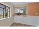 A bright and open breakfast bar area with white wainscoting and a view into the kitchen at 502 Hammock Pine Blvd # 502, Clearwater, FL 33761