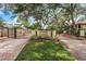 View of community entrance gate with Hammock Pine signage surrounded by mature trees at 502 Hammock Pine Blvd # 502, Clearwater, FL 33761