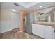 Bright kitchen features stainless steel refrigerator, tile flooring, and granite countertops at 502 Hammock Pine Blvd # 502, Clearwater, FL 33761