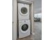 Convenient, stacked washer and dryer with easy access to the living area at 502 Hammock Pine Blvd # 502, Clearwater, FL 33761