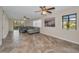 Open-concept living room featuring neutral tones, tile flooring, and ample natural light at 502 Hammock Pine Blvd # 502, Clearwater, FL 33761