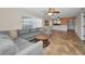 Bright open-concept living room featuring tile floors, a ceiling fan, and a comfortable gray sectional sofa at 502 Hammock Pine Blvd # 502, Clearwater, FL 33761