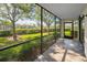 Relaxing screened patio with lush views of the lawn and neighborhood at 502 Hammock Pine Blvd # 502, Clearwater, FL 33761