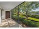 Screened patio offering outdoor living space with a view of the landscaped yard at 502 Hammock Pine Blvd # 502, Clearwater, FL 33761