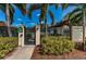 Community pool area with gated entrance, palm trees, and meticulously maintained landscaping at 502 Hammock Pine Blvd # 502, Clearwater, FL 33761
