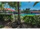 Community pool featuring a spacious deck area with lounge chairs, cabana and mature landscaping at 502 Hammock Pine Blvd # 502, Clearwater, FL 33761