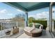 Balcony with cozy round rattan seating and green accents at 531 Bimini Bay Blvd, Apollo Beach, FL 33572