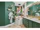 Stylish bathroom featuring a soaking tub, green cabinetry, and luxurious decor at 531 Bimini Bay Blvd, Apollo Beach, FL 33572