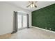 An empty bedroom with an accent wall, an exterior door, and neutral tiling at 531 Bimini Bay Blvd, Apollo Beach, FL 33572
