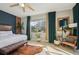 Bright and airy main bedroom with a large window and green curtains at 531 Bimini Bay Blvd, Apollo Beach, FL 33572