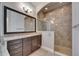 Gorgeous bathroom featuring a large shower and dark wood cabinets with granite countertops at 5316 Candler View Dr, Lithia, FL 33547
