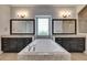 Luxurious bathroom with soaking tub, dual vanities, granite countertops and stylish lighting at 5316 Candler View Dr, Lithia, FL 33547