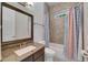 Well-lit bathroom featuring granite counters, a bathtub, and a stylish patterned shower curtain at 5316 Candler View Dr, Lithia, FL 33547