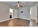 Bedroom with hardwood floors, ceiling fan, an adjacent bathroom and an entry to another room at 5316 Candler View Dr, Lithia, FL 33547