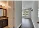 Bedroom featuring hardwood flooring, bright windows and modern ceiling fan next to bathroom at 5316 Candler View Dr, Lithia, FL 33547