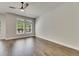Bedroom features hardwood floors, ceiling fan, and lots of natural light from the windows at 5316 Candler View Dr, Lithia, FL 33547