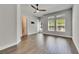 Bright bedroom featuring hardwood floors, ceiling fan, and natural light from the windows at 5316 Candler View Dr, Lithia, FL 33547