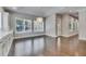 Dining room has hardwood floors, modern chandelier, and multiple windows for ample natural light at 5316 Candler View Dr, Lithia, FL 33547