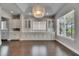 Open dining room boasting hardwood floors, built-in cabinetry, and a modern chandelier at 5316 Candler View Dr, Lithia, FL 33547