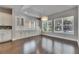 Bright dining room featuring dark hardwood floors, white cabinetry, and a decorative chandelier at 5316 Candler View Dr, Lithia, FL 33547