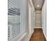 Hallway with hardwood floors, white trim, and natural light from the window at 5316 Candler View Dr, Lithia, FL 33547
