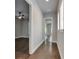 Hallway has hardwood floors and neutral colors with openings to other rooms and natural light at 5316 Candler View Dr, Lithia, FL 33547