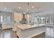 Bright kitchen with a large island, stainless steel hood, custom cabinets, and eat in breakfast area at 5316 Candler View Dr, Lithia, FL 33547