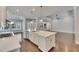 Bright, open kitchen with white cabinets, quartz countertops, and hardwood floors throughout the home at 5316 Candler View Dr, Lithia, FL 33547